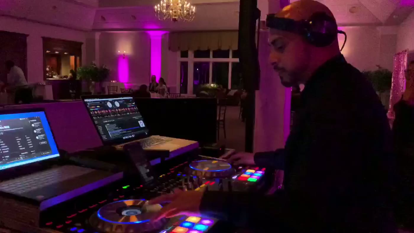 Kyd Sanchez mixing live behind the DJ booth at a Massachusetts wedding